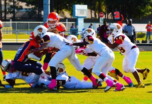 Trojans D-Line pushing the ball carrier behind the line of scrimmage