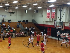 Kenny works the ball around the court attempting to find the open man against  the Braves zone defense.